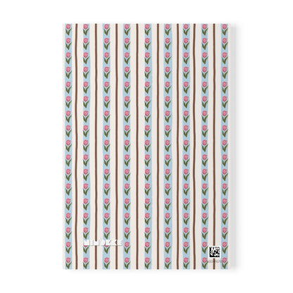 A Softcover A5 Notebook or journal cover featuring a repeating pattern of pink tulips with green stems on alternating light blue and beige vertical stripes, with the brand name 'Nimokke' printed near the bottom.