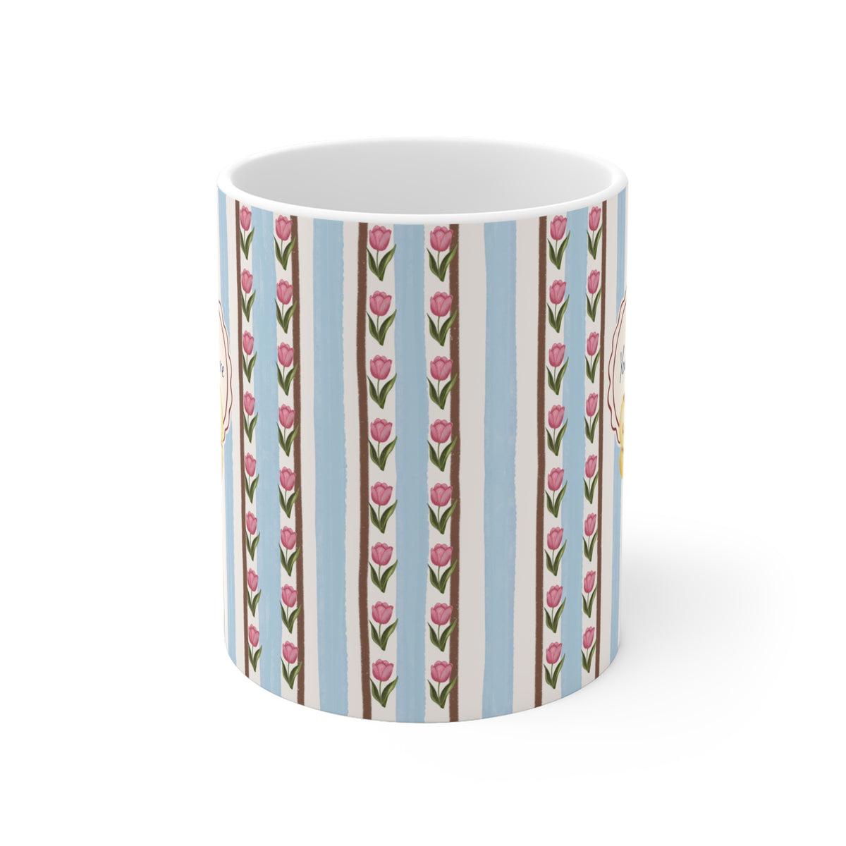 A white ceramic mug featuring a vertical striped pattern with light blue, beige, and brown stripes, decorated with pink tulip motifs and small yellow floral accents.