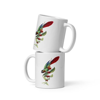 A white ceramic mug with a colorful illustration of a parakeet bird perched on a branch with leaves and berries.